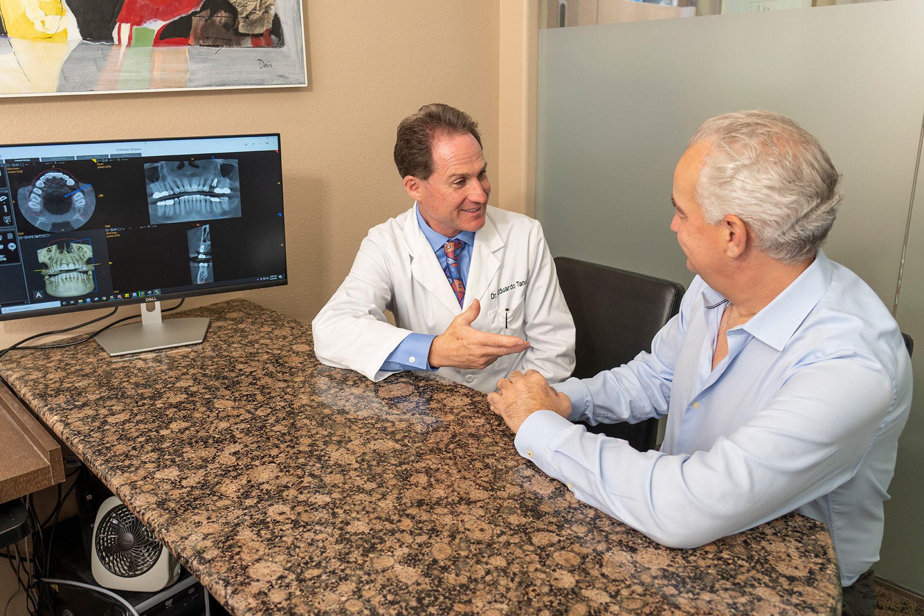 Dr. Tanur and a patient speaking to each other