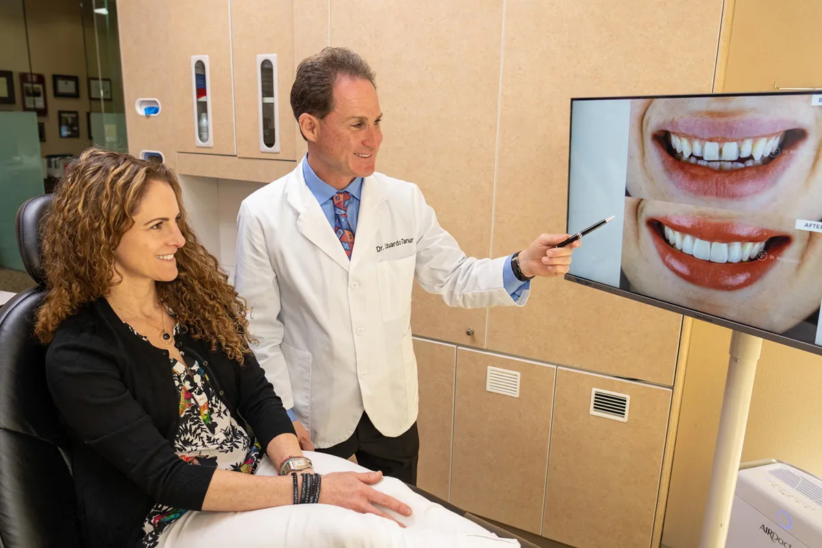 Dr. Tanur showing a patient a before/after image