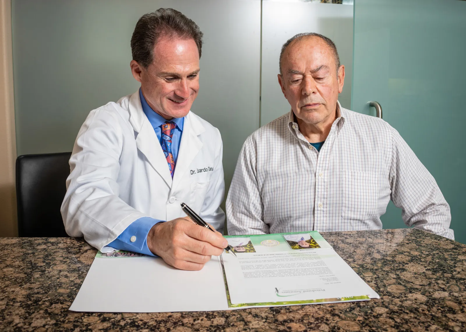 Dr. Ovadia and a patient looking into paperwork together