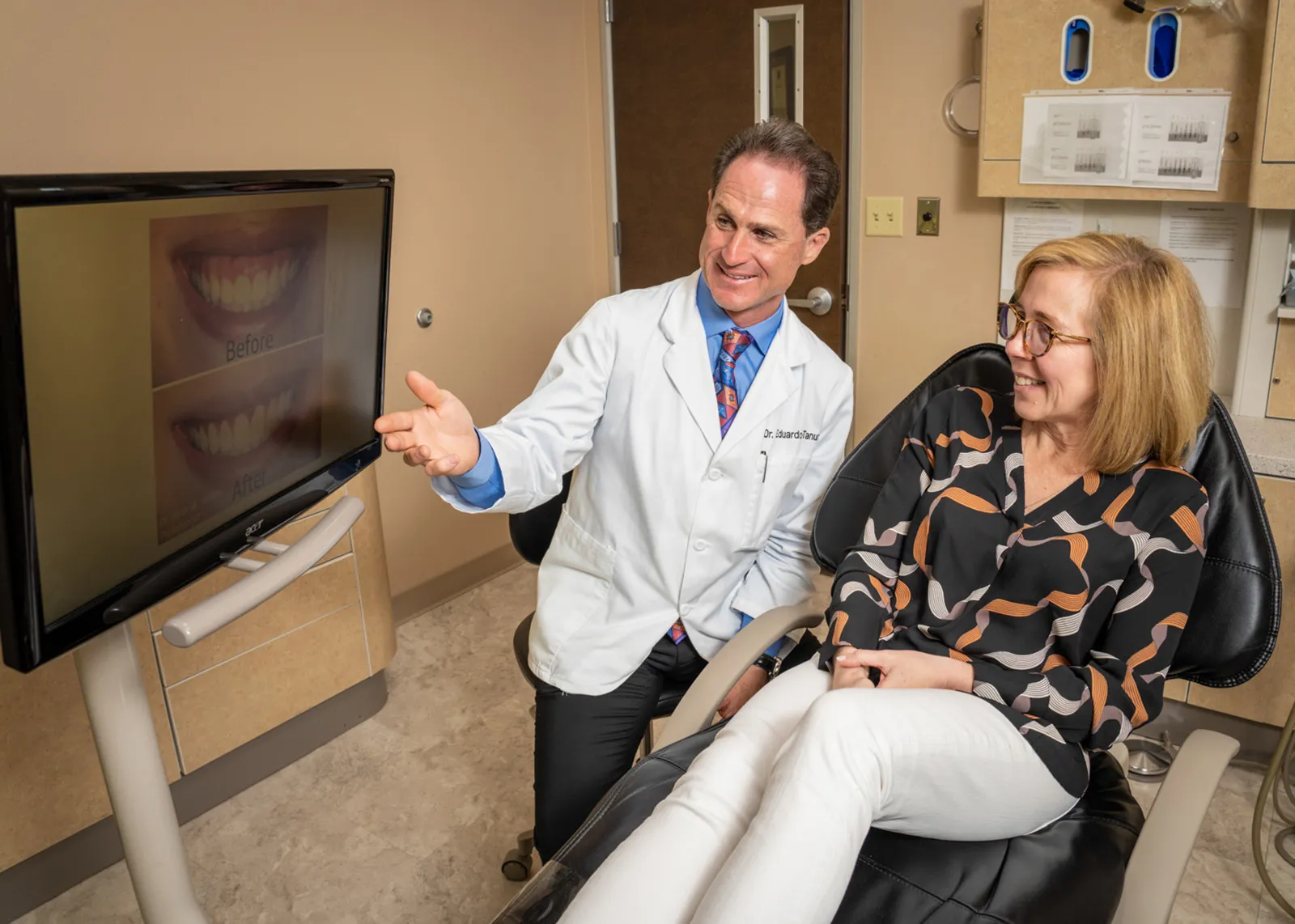 Dr. Tanur and a patient examining a before/after image