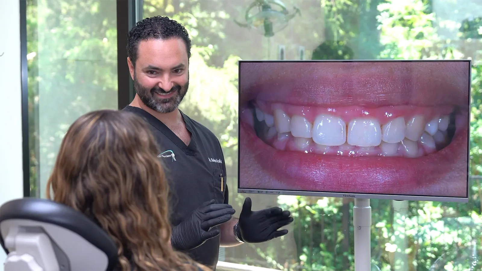 Dr. Ovadia discussing with a patient oral hygiene
