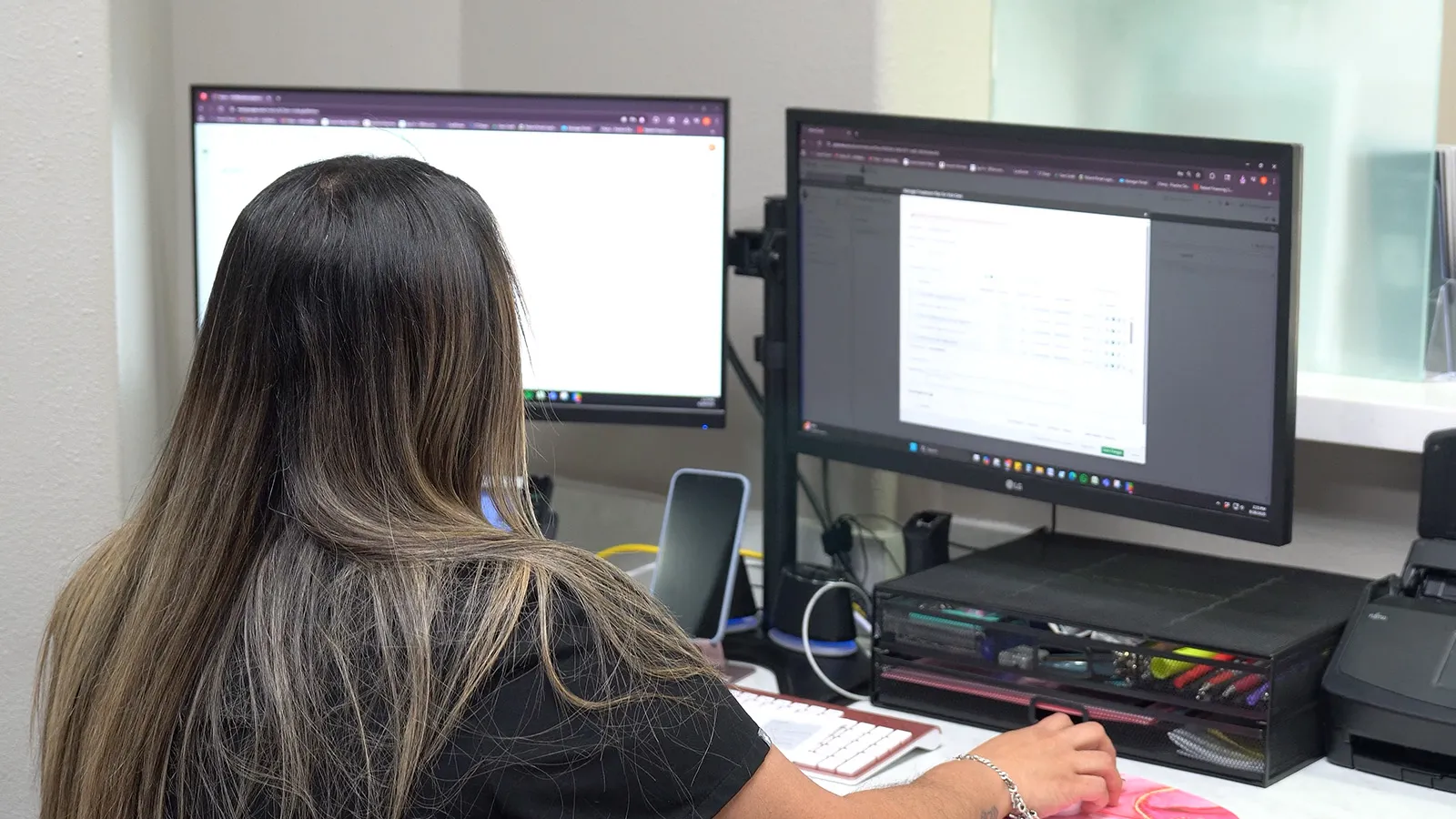 A dental assistant working on the computer