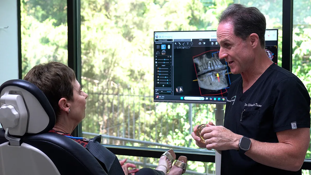 Dr. Tanur explaining treatments to a patient