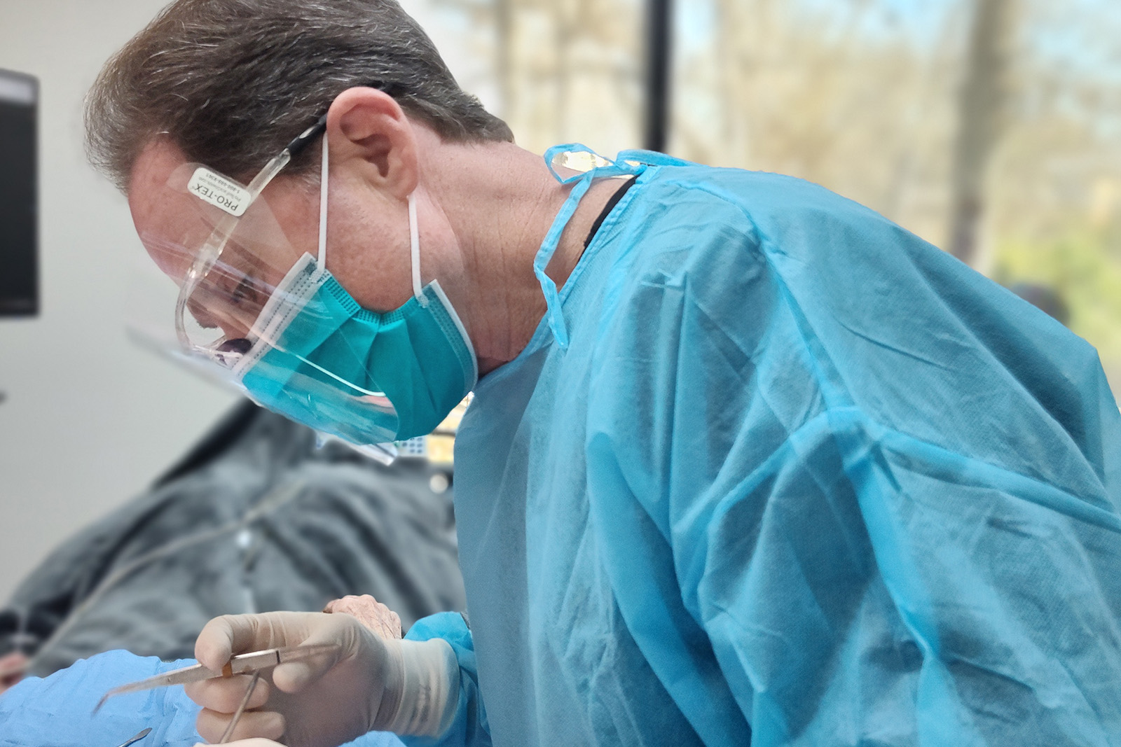 Dr. Tanur working on a patient