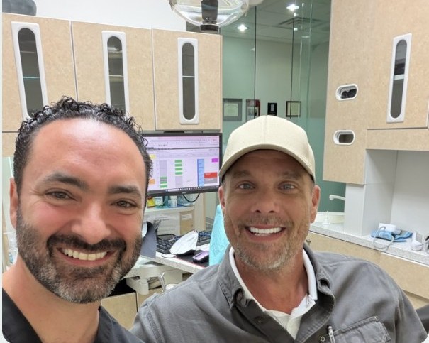 Jeremi smiling with Dr. Ruben Ovadia after New Teeth in One Day at Dallas Periodontal Associates